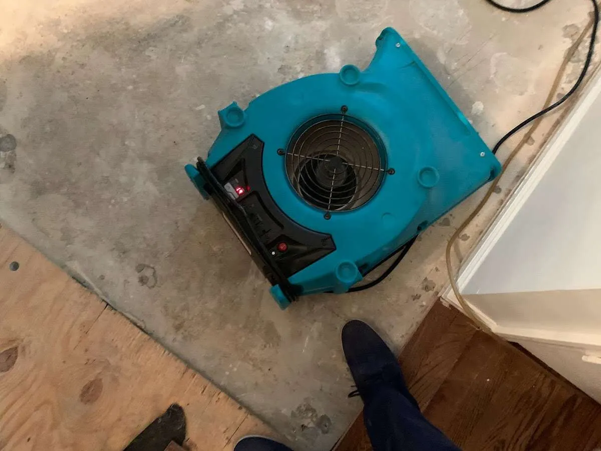 Air mover drying subfloor during Commercial Water Damage Restoration in Huntertown